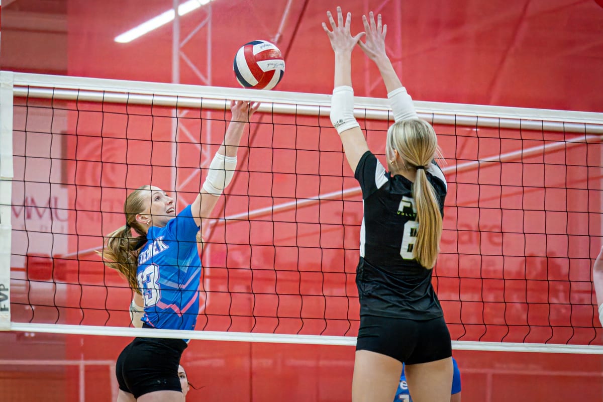 Adelaide Bezemek sending a ball over the net